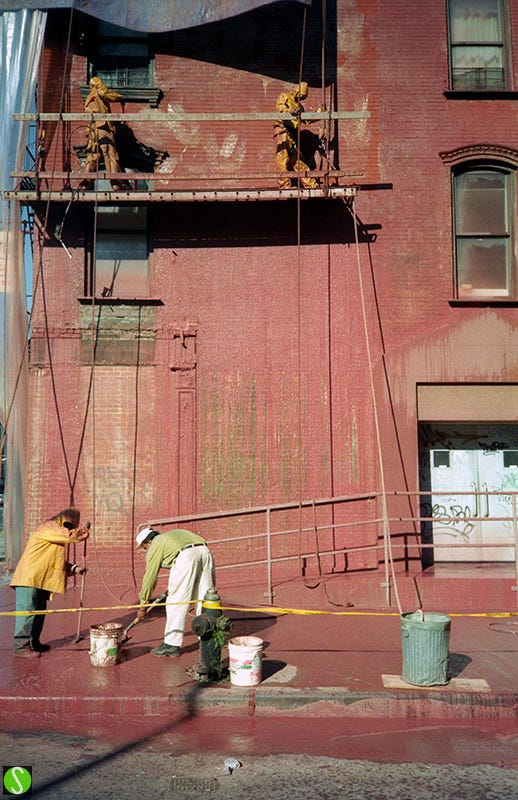 1995 photo of work men cleaning a building 