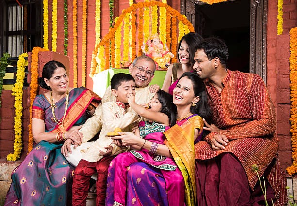 Indian Family Eating Sweet Laddu On Ganesha Festival Stock Photo - Download  Image Now - iStock
