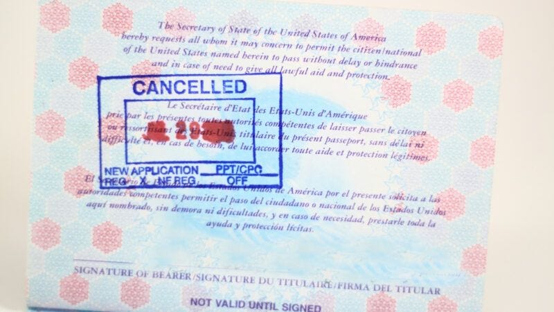 U.S. passport open to a page with a "CANCELLED" stamp | Luckydoor | Dreamstime.com 