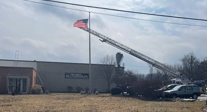 A firetruck with a flag on top of a pole

Description automatically generated