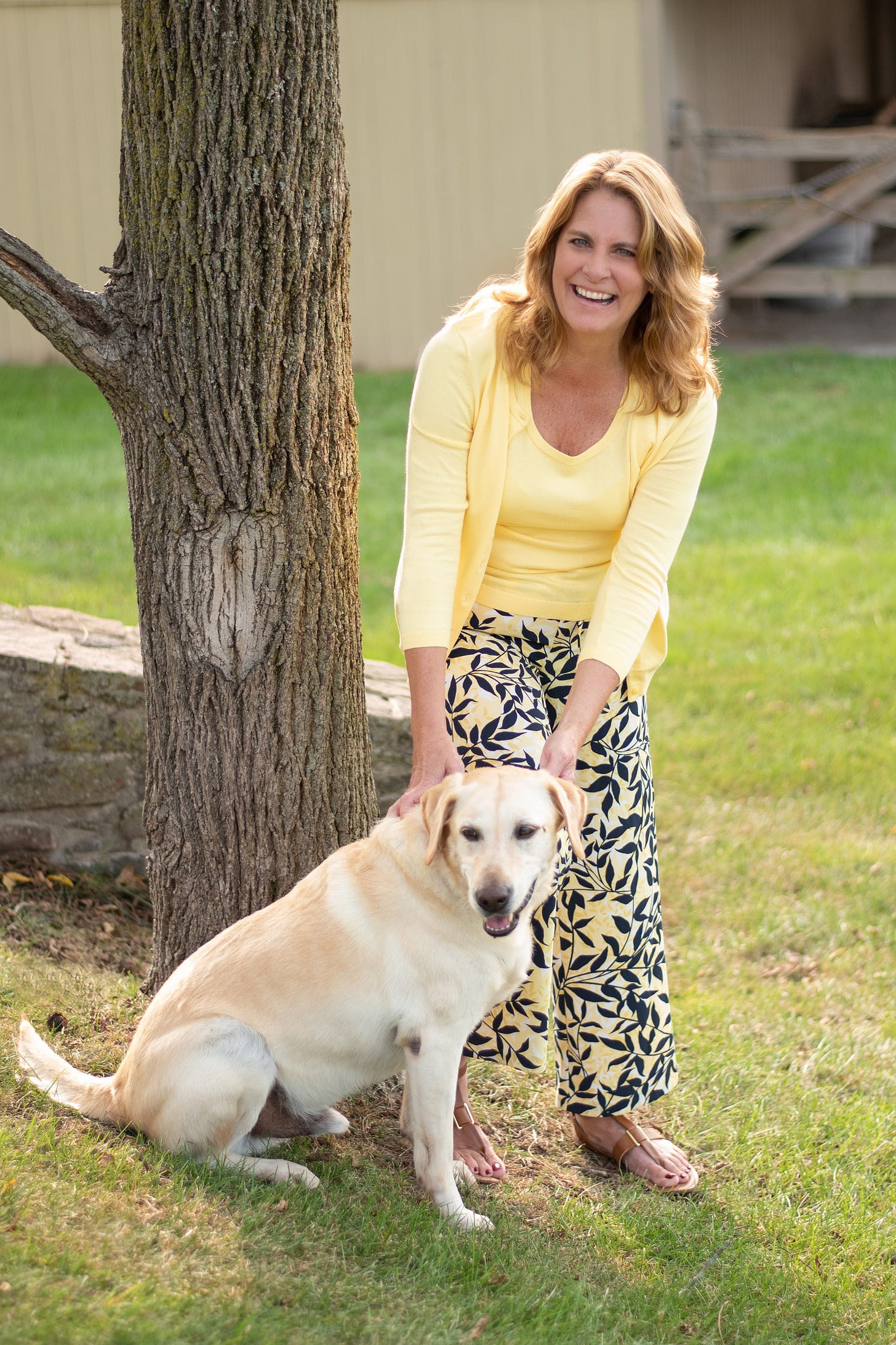 Joanne McHugh poses with her yellow Lab Henry