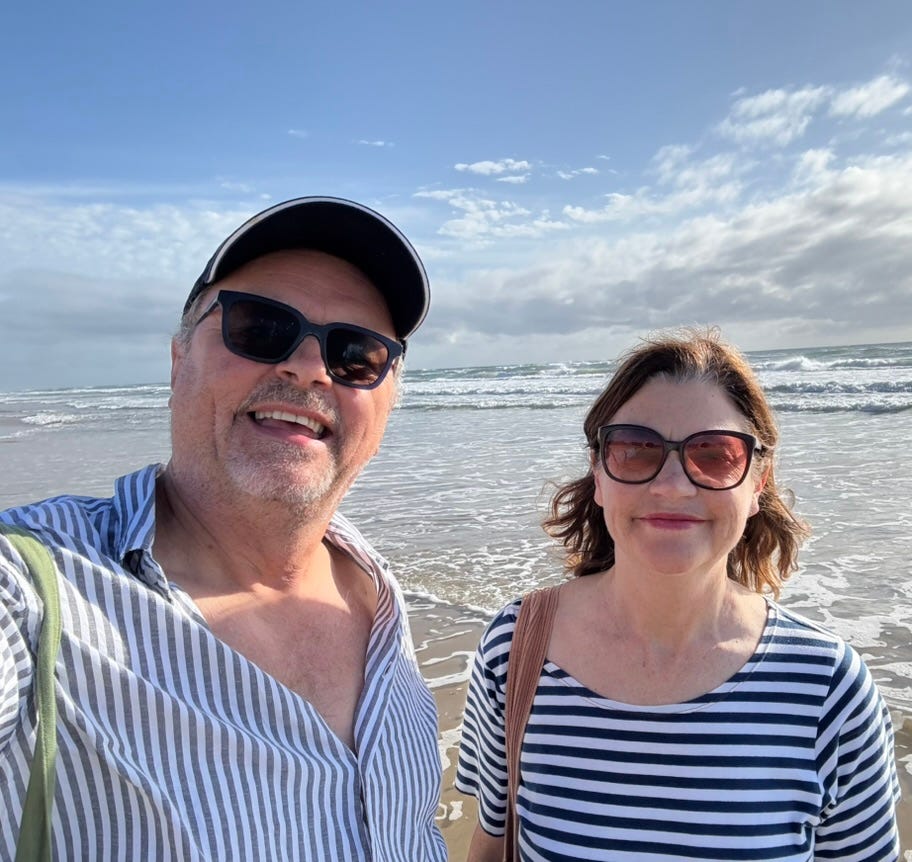 A selfie taken by the author (68) with his wife on a beach in Queensland Australia.