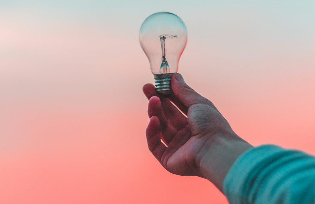 person holding light bulb