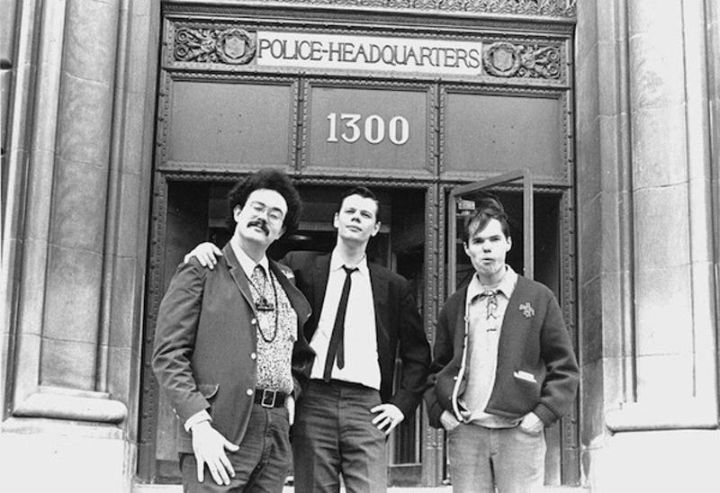 three men in front of police headquarters