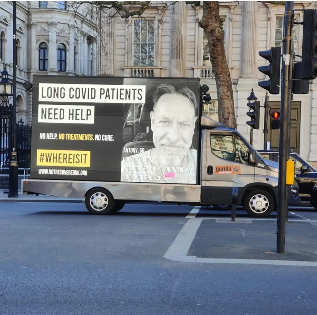 Picture shows the #whereisit van in London. The van has an image of Antony, 55, UK and the text "Long Covid patients need help. No help. No treatments. No cure. #WhereIsIt"