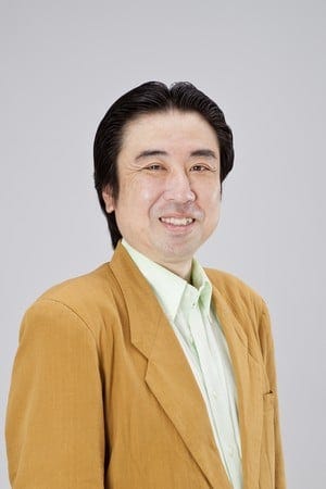 Headshot of Eiji Yanagisawa wearing a light orange jacket and white shirt and smiling