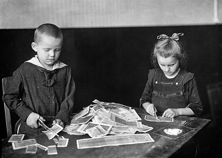 Germany children playing with banknotes rendered valueless through hyperinflation, circa 1919. Germany children playing with banknotes rendered valueless through hyperinflation, circa 1919.