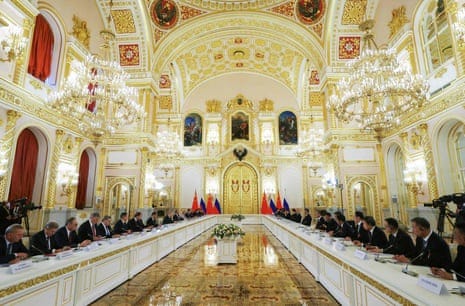Putin, Xi and members of both delegations hold a meeting at the Kremlin.