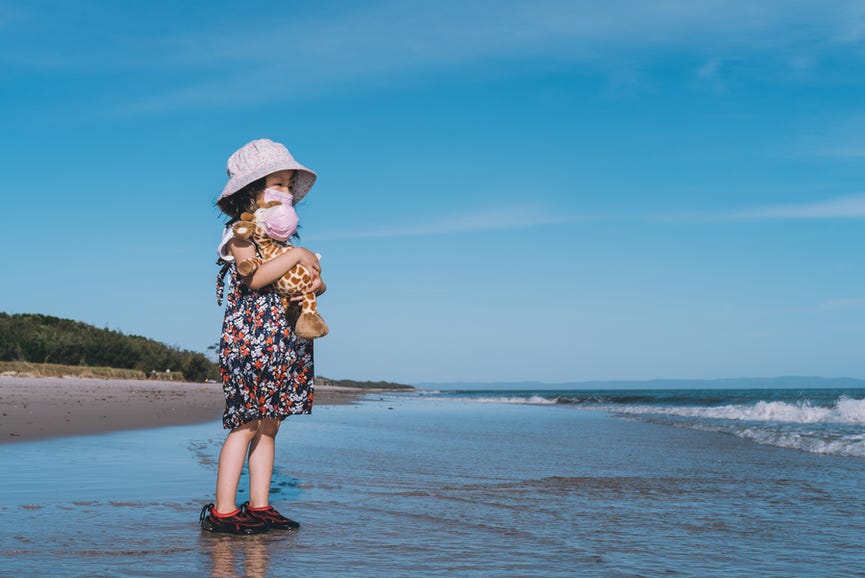 little girl standing on beach