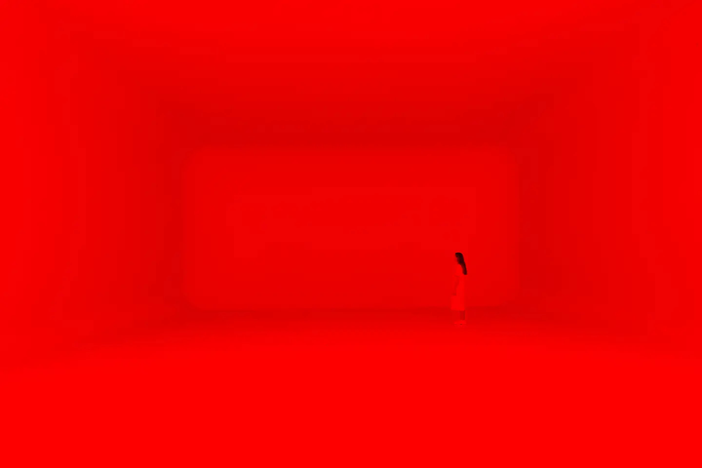 A guest is enveloped in bright red light inside of James Turrell's large Miami experience at Superblue A guest is enveloped in bright red light inside of James Turrell's large Miami experience at Superblue
