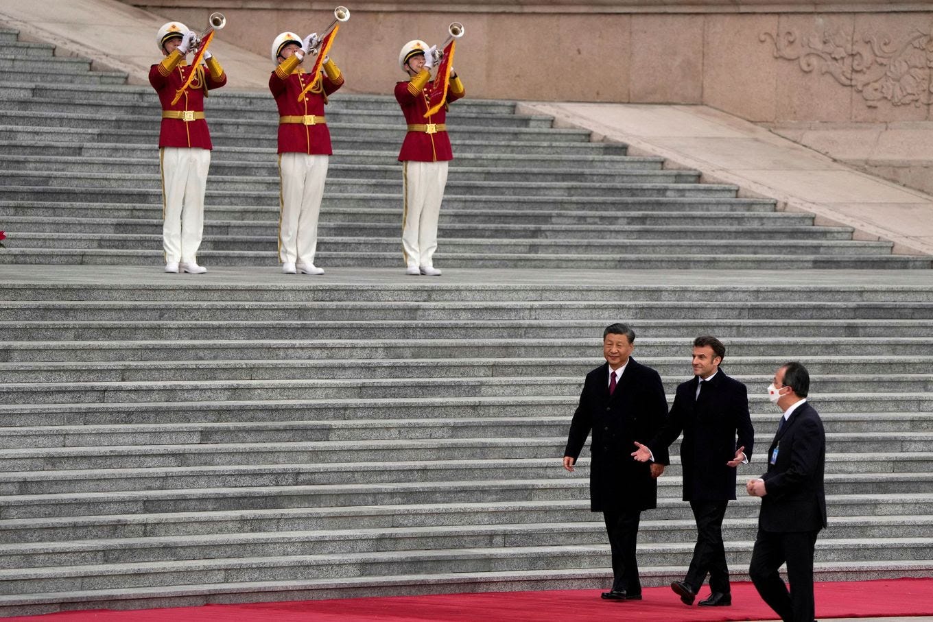 French President Emmanuel Macron walks with Chinese President Xi Jinping during a welcome ceremony outside the Great Hall of the People in Beijing on April 6. (Ng Han Guan/Pool/Reuters/via REUTERS)