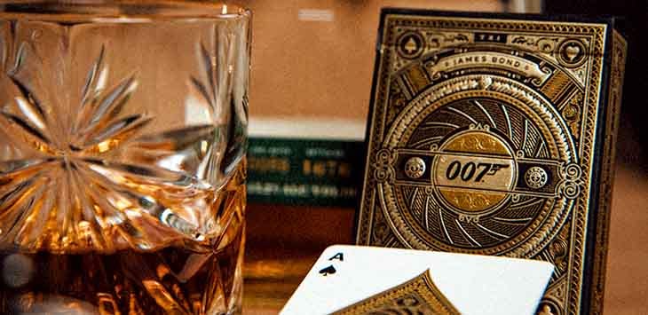 Photo of whisky glass and 007-branded playing cards.