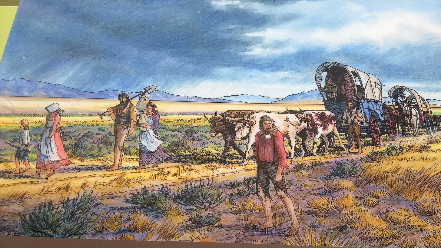 Ragged migrants with wagons, men with heavy heards, tramping across the Nevada desert wuth covered wagons