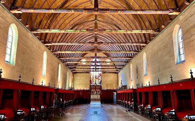 A long room with a wooden ceiling and red curtains

Description automatically generated with medium confidence