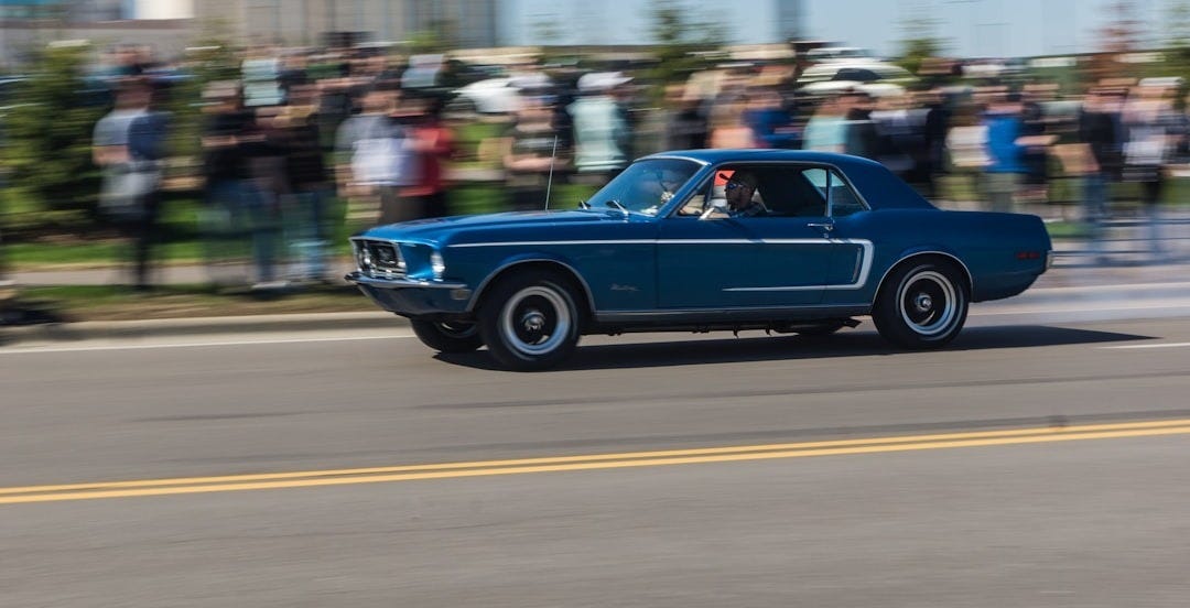 blue sedan on road