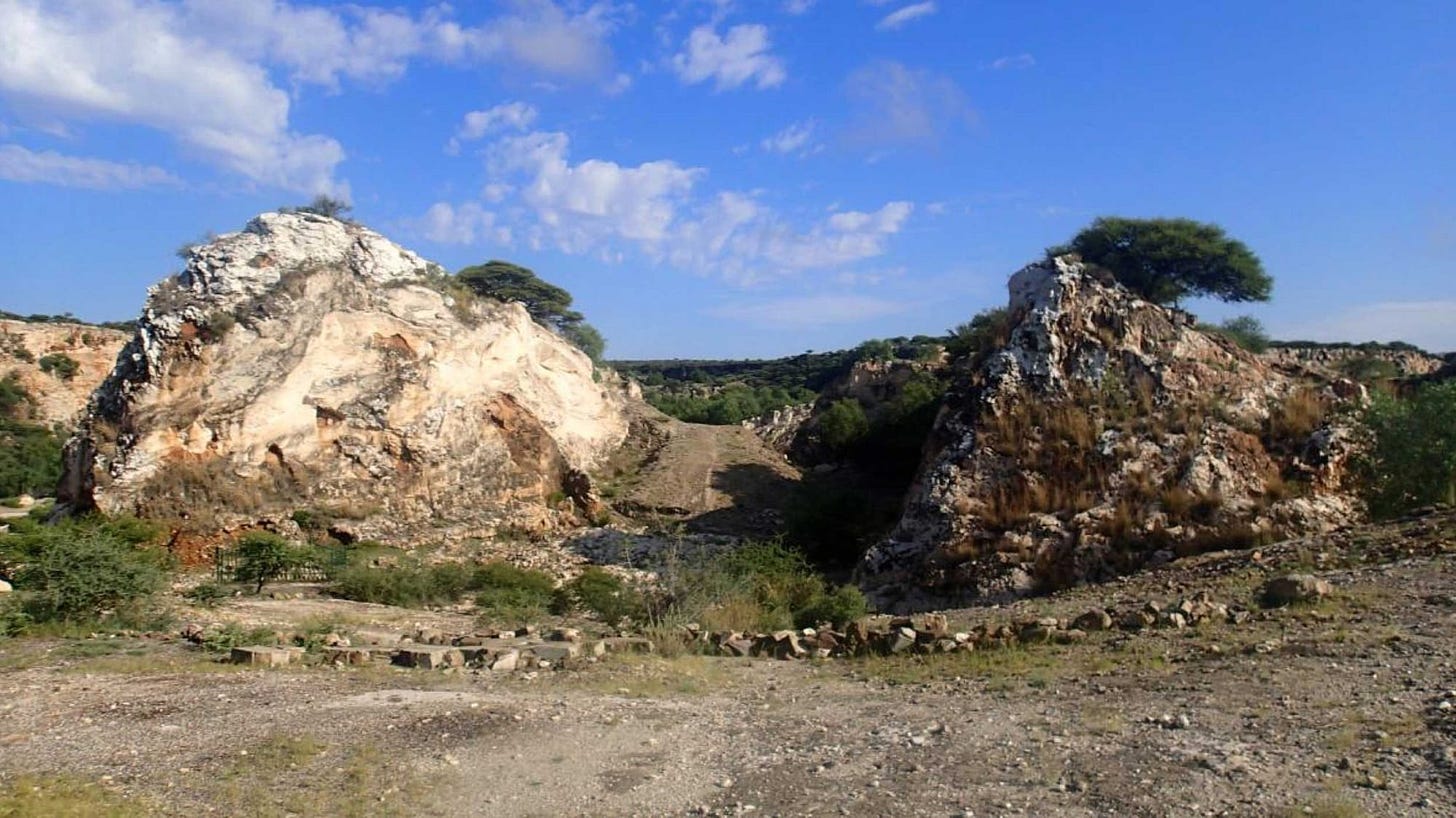 Two hummocks of rock with bare landscape around them Two hummocks of rock with bare landscape around them