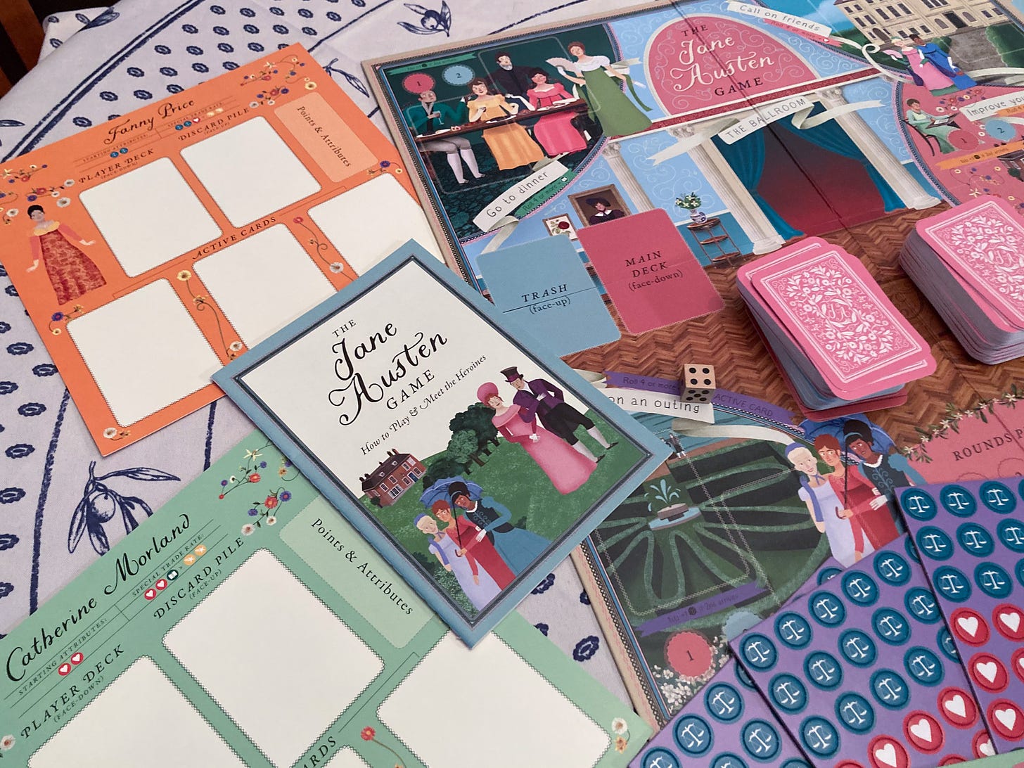 Game pieces, game boards, and the instruction booklet for "The Jane Austen Game."