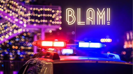 Blam: red and blue police lights flash beneath a banister covered in twinkle lights