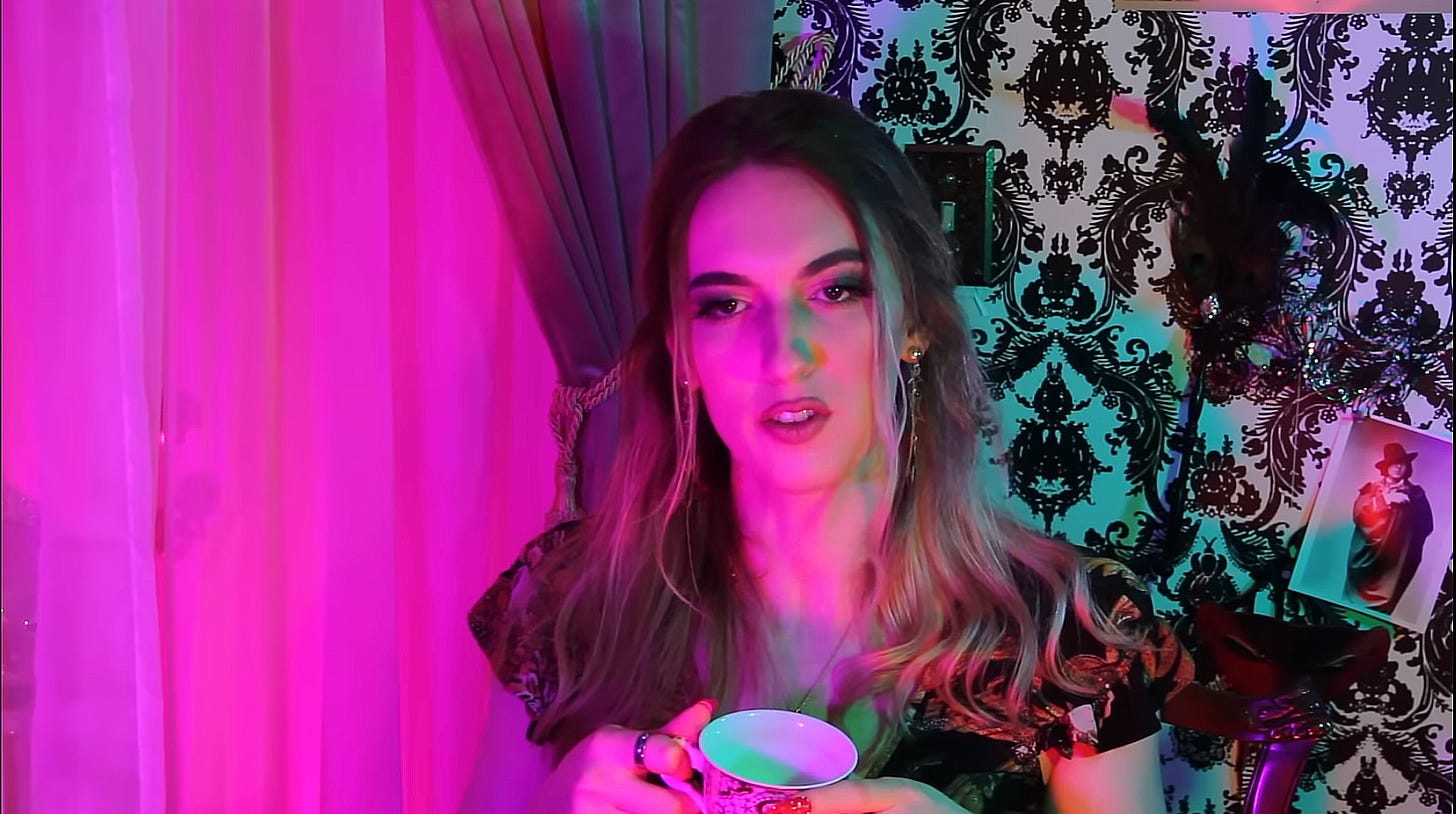 Natalie Wynn in The Aesthetic, portraying a woman holding tea in bisexual lighting.