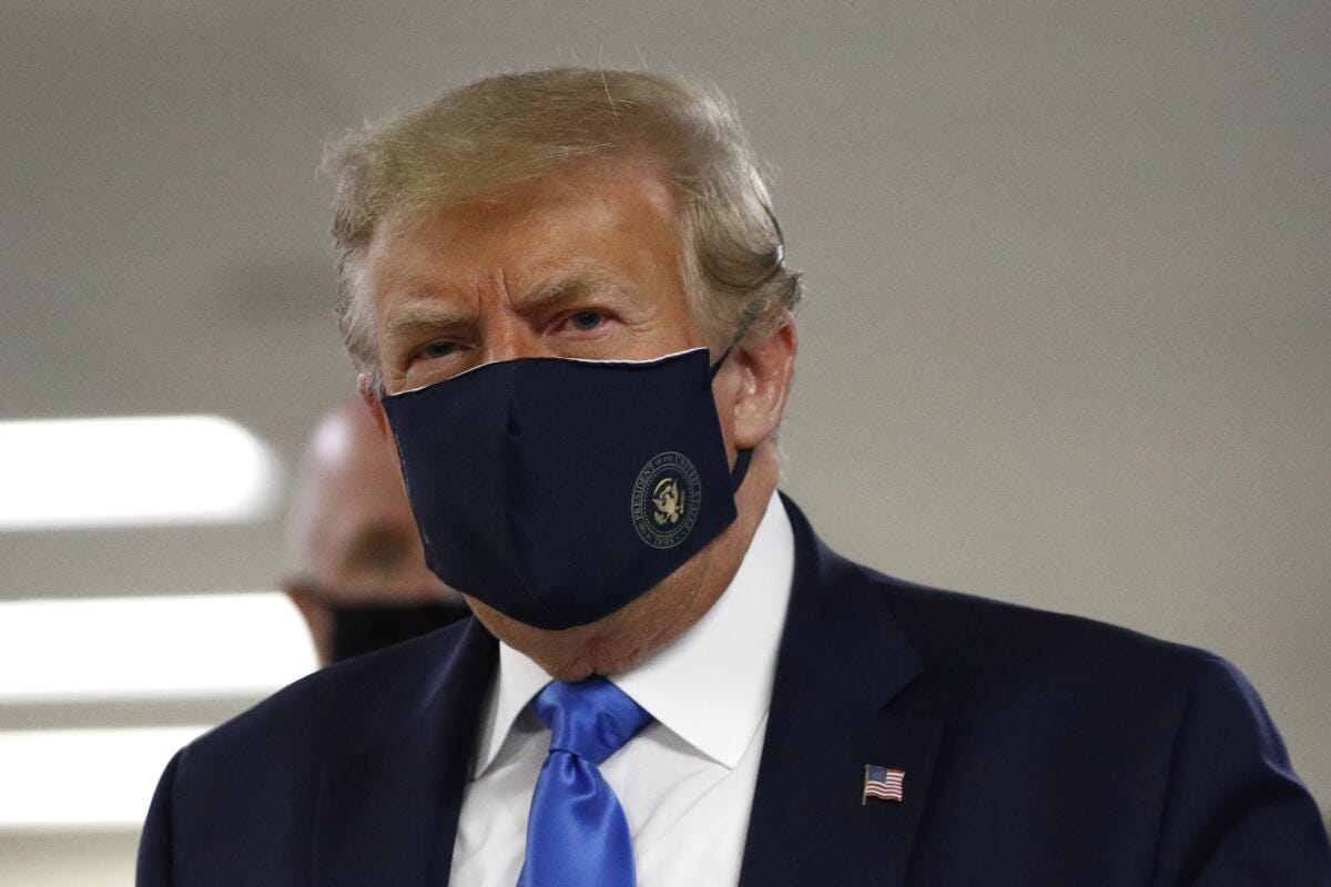 President Trump wears a face mask at Walter Reed hospital in Bethesda, Md., on Saturday.