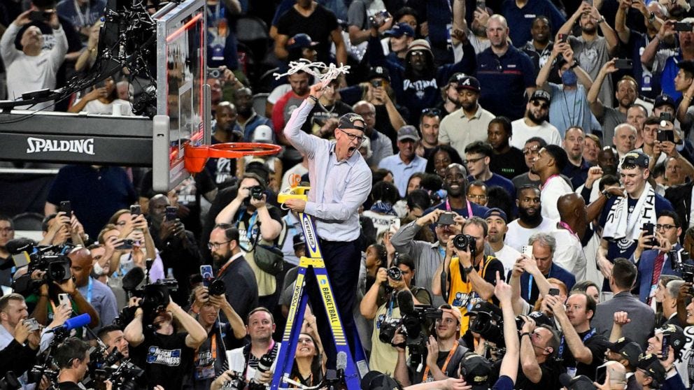 PHOTO: Head coach Dan Hurley of the Connecticut Huskies reacts as he cuts down the net after defeating the San Diego State Aztecs 76-59 during the NCAA Men's Basketball Tournament National Championship game at NRG Stadium, April 03, 2023 in Houston.