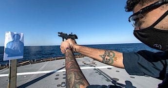 Cryptologic Technician Technical 3rd Class Tyler Manson, from Palm Bay, Florida, fires an M9 handgun during a live-fire training exercise on the flight deck of U.S. 7th Fleet flagship USS Blue Ridge, March 15, 2021. (U.S. Navy photo by Mass Communication Specialist 3rd Class Matt Hall)