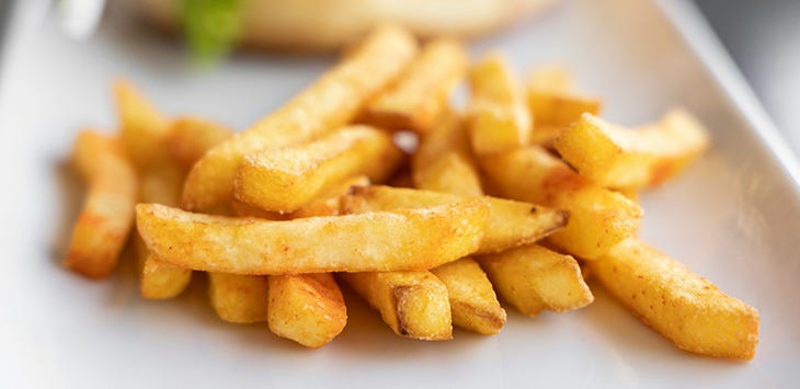 Photo of some chips (that is, "French fries") on a plate.