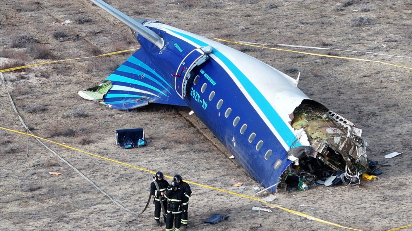 A drone view shows rescuer workers at the crash site of an Azerbaijan Airlines passenger plane on 25 December