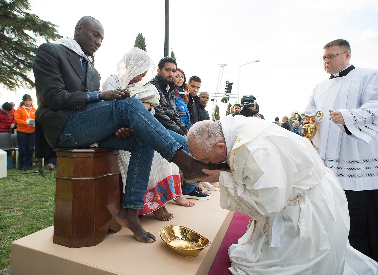 Pope Francis kisses the foot of a man during the foot-washing ritual at the Castelnuovo di Porto refugees center near Rome, Italy on March 24, 2016.