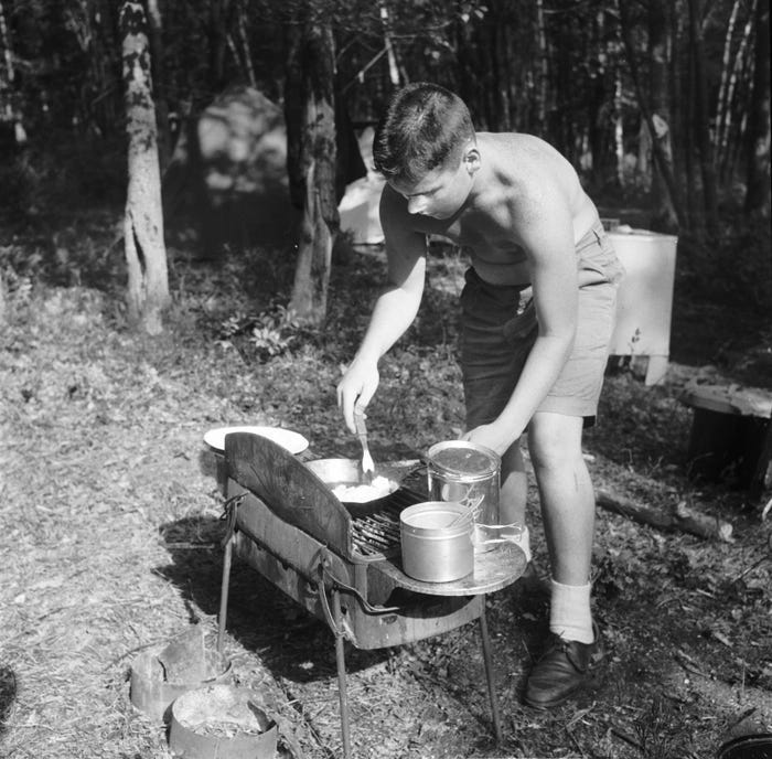 boy campsite cooking