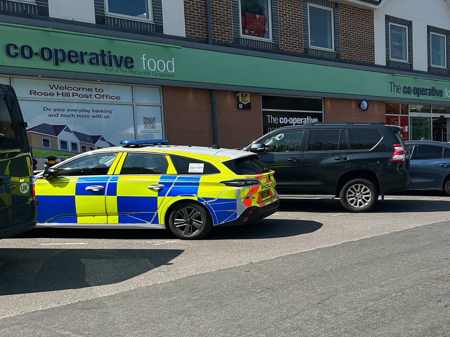 A police car parked outside a co-op store in Rose Hill, Oxford