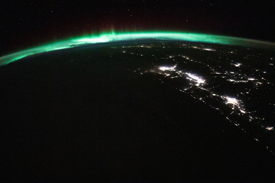 A view from outerspace of nighttime Earth and the northern lights