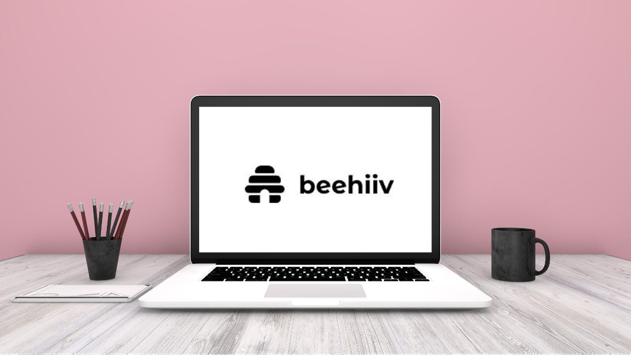 A laptop with the beehiv logo on the screen.