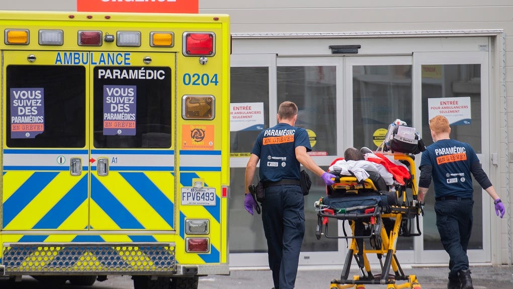 Paramedics transfer a person into a hospital in Montreal, Thursday, July 14, 2022 amid the COVID-19 pandemic. (THE CANADIAN PRESS/Graham Hughes)