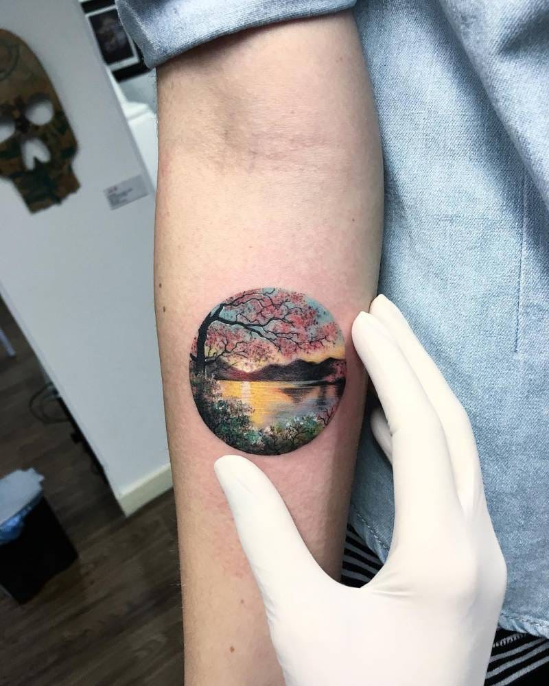Landscape tattoo on the right inner forearm.