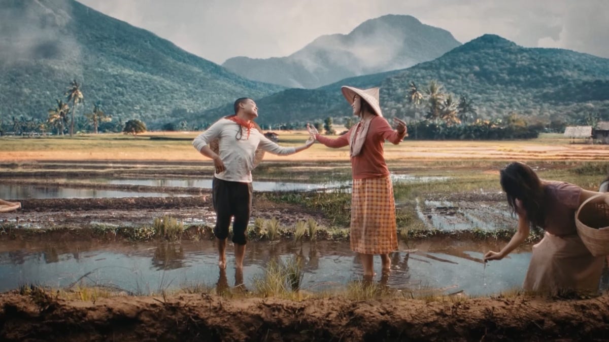 Rommel and Lily dancing in a rice paddy.