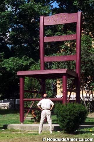 Photo of a man looking up at the 25 foot tall Gardner Chair.