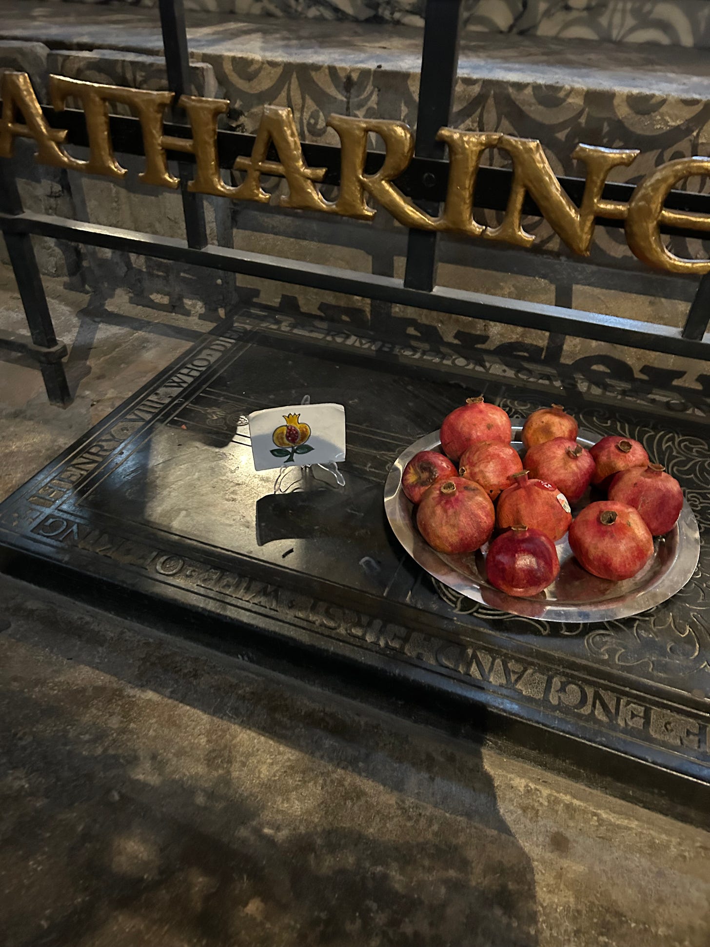A plate of pomegranates on a tomb, in a silver dish
