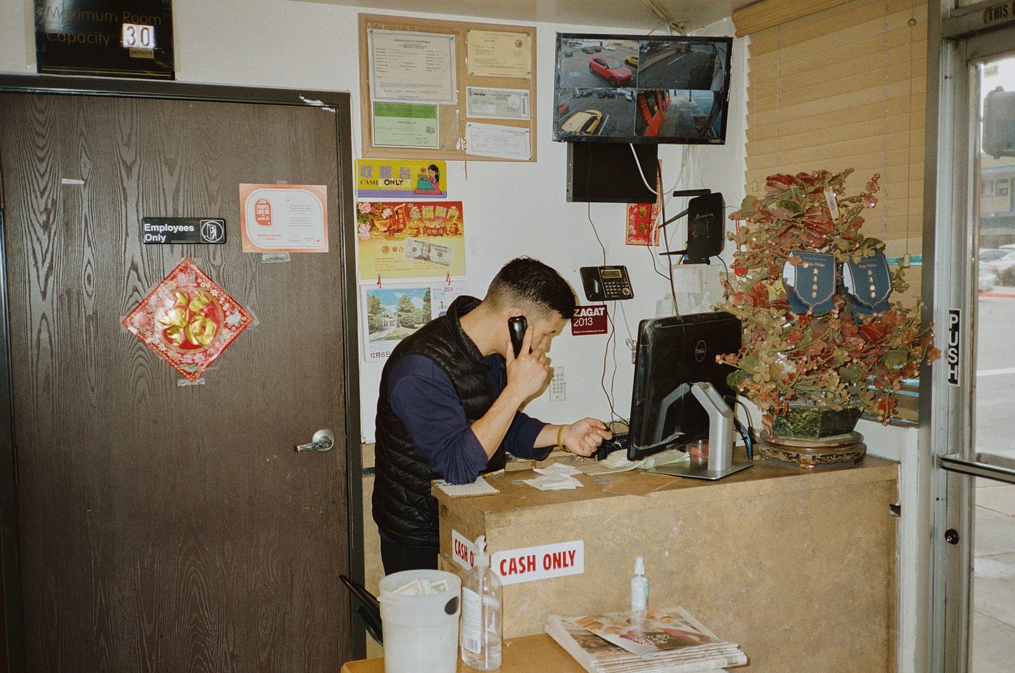 Denny Mu at the register of Mandarin Noodle House