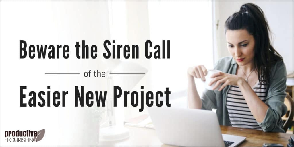 A woman sitting at a desk with her laptop and a mug. Text Overlay: Beware the Siren Call of the Easier New Project