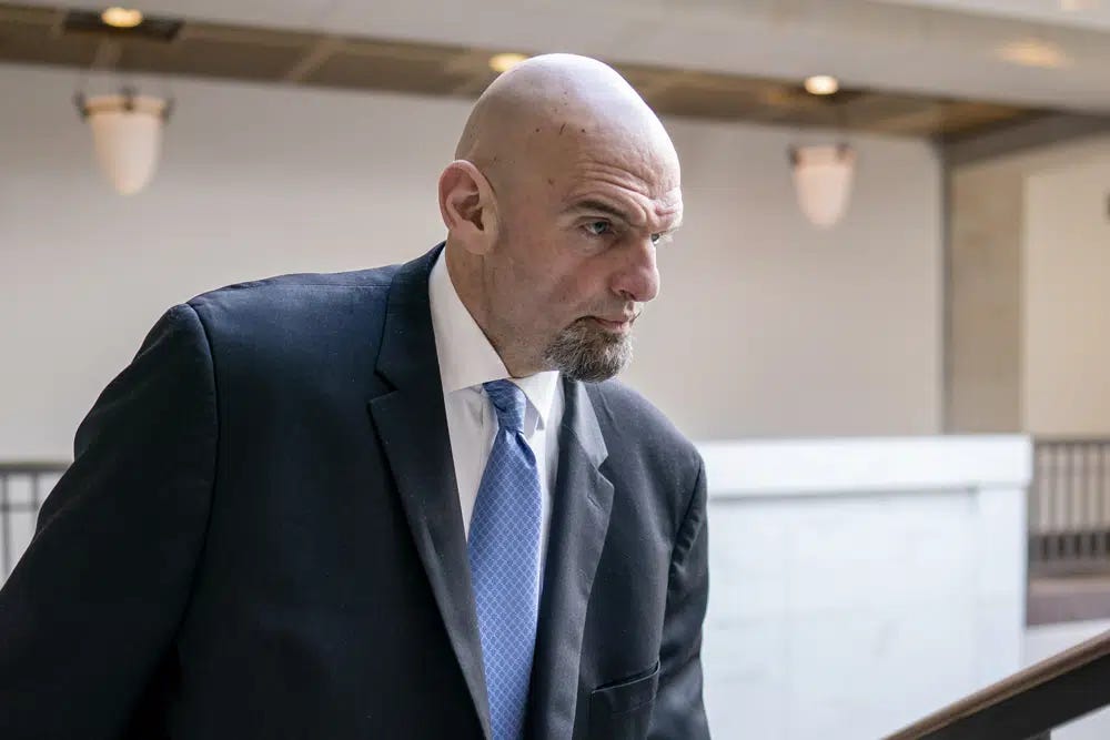 FILE - Sen. John Fetterman, D-Pa., leaves an intelligence briefing on the unknown aerial objects the U.S. military shot down this weekend at the Capitol in Washington, Feb. 14, 2023. Fetterman is in Walter Reed National Military Medical Center to seek treatment for clinical depression. His office said Thursday that Fetterman checked himself in Wednesday night. (AP Photo/J. Scott Applewhite, File)
