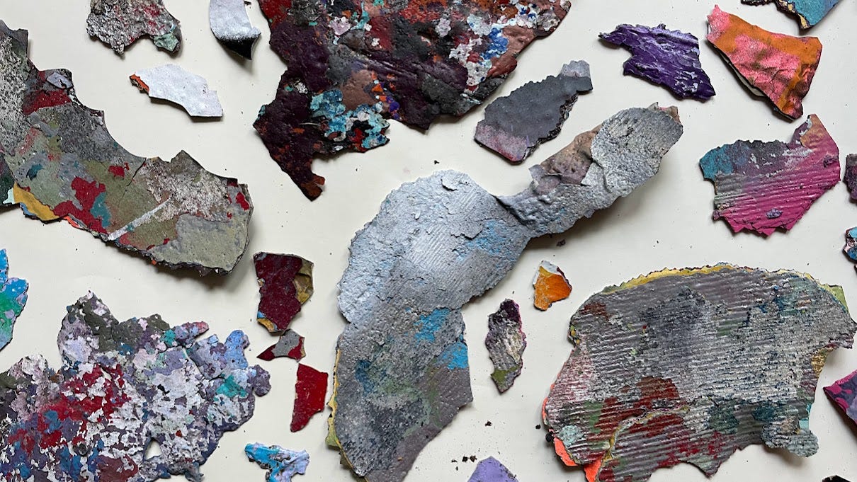 large, irregular shards of paint that feel from buildings it adorned, which were gleaned from Vernonia mill; these abstract pieces are in irregular shapes and are a variety of colors, from silver, white, black to magenta, red, orange, and aqua