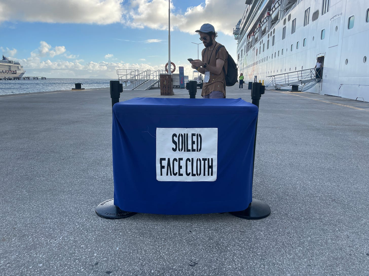 A receptacle for collecting used face clothes outside of the cruise ship at dock.