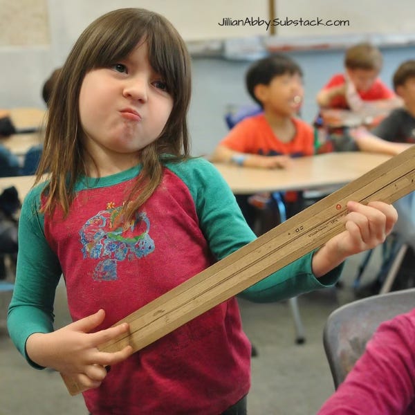 An AI-generated image of a young girl with long brown hair and a red and blue shirt pretending to play guitar on a wooden ruler.