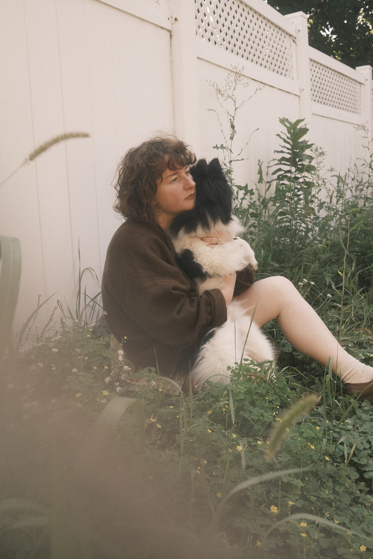 Me holding my pomeranian dog, Bandit, in the garden