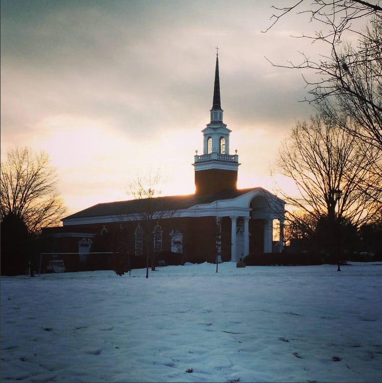 The sun rises behind Snidow Chapel on the campus of the University of Lynchburg in Virginia.