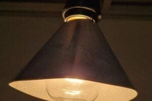 A lampshade coated with a catalyst uses heat from an incandescent bulb to destroy indoor air pollution.