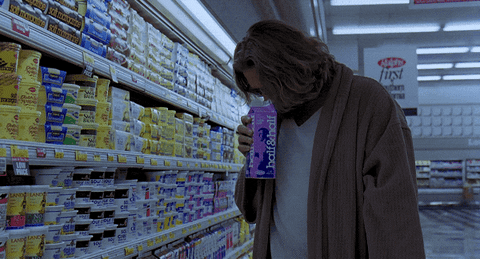 The Dude sniffs a litre of milk at the supermarket