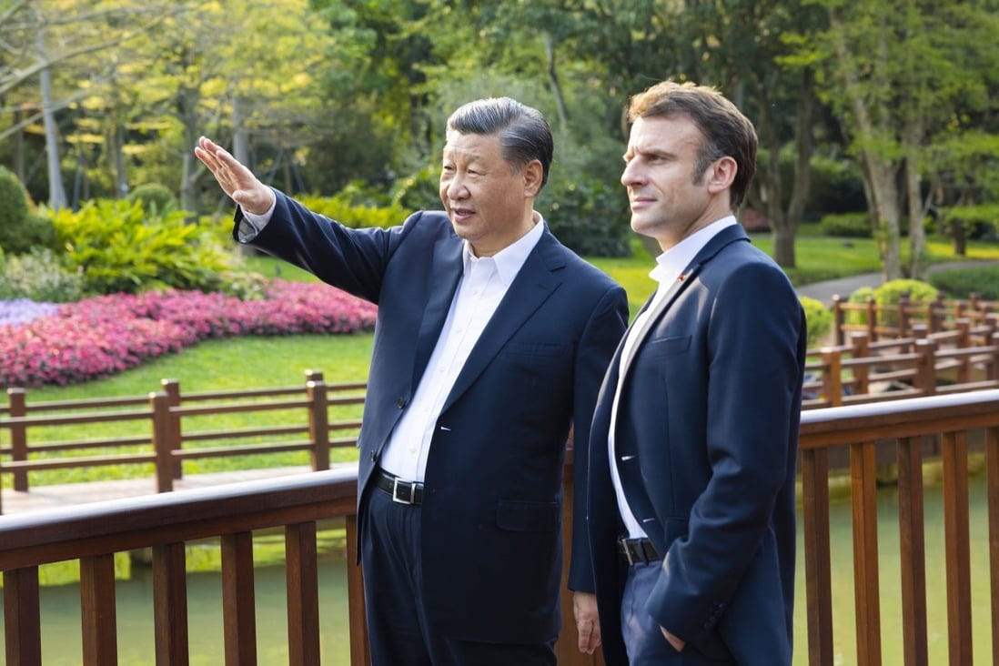 Chinese leader Xi Jinping and French President Emmanuel Macron stroll through the Pine Garden in Guangzhou on Friday. Photo: Xinhua