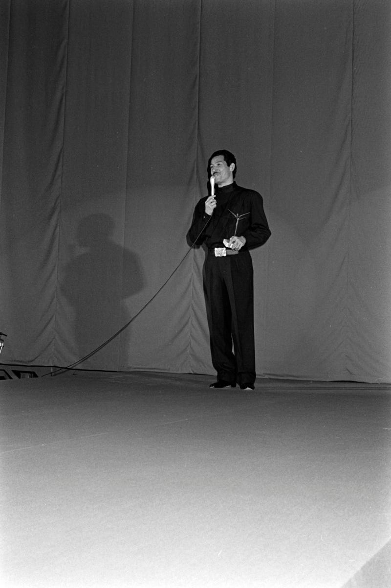 Issey Miyake accepts his award at the fashion show at Neiman Marcus awards presentation, 1984.